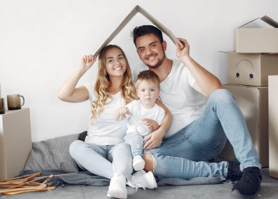 Family moving. People use a boxes. Little boy with parents.